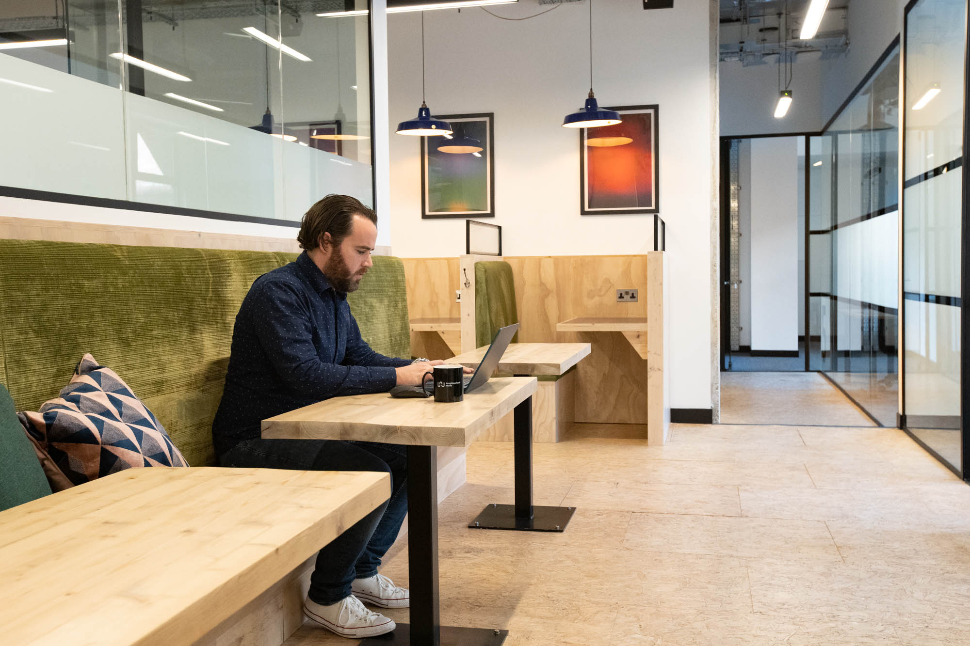 Man using coworking desk at Neighbourhood Works