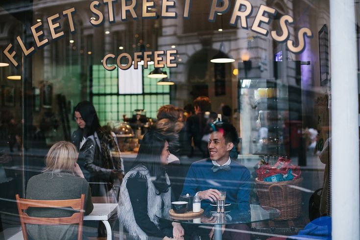 People having coffee inside Fleet Street Press, The Strand