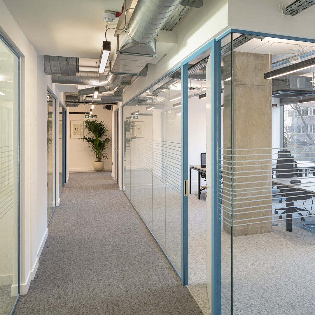 Modern private office as part of an enterprise suite in Putney, featuring glass partitions, ergonomic chairs, and a bright, professional layout designed for team productivity.