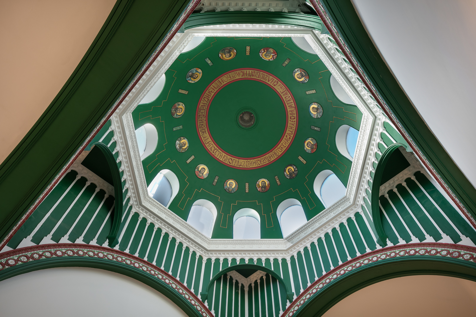 Interior view of a converted chapel event space in Marylebone, showcasing a green dome ceiling with original paintings and intricate architectural details.