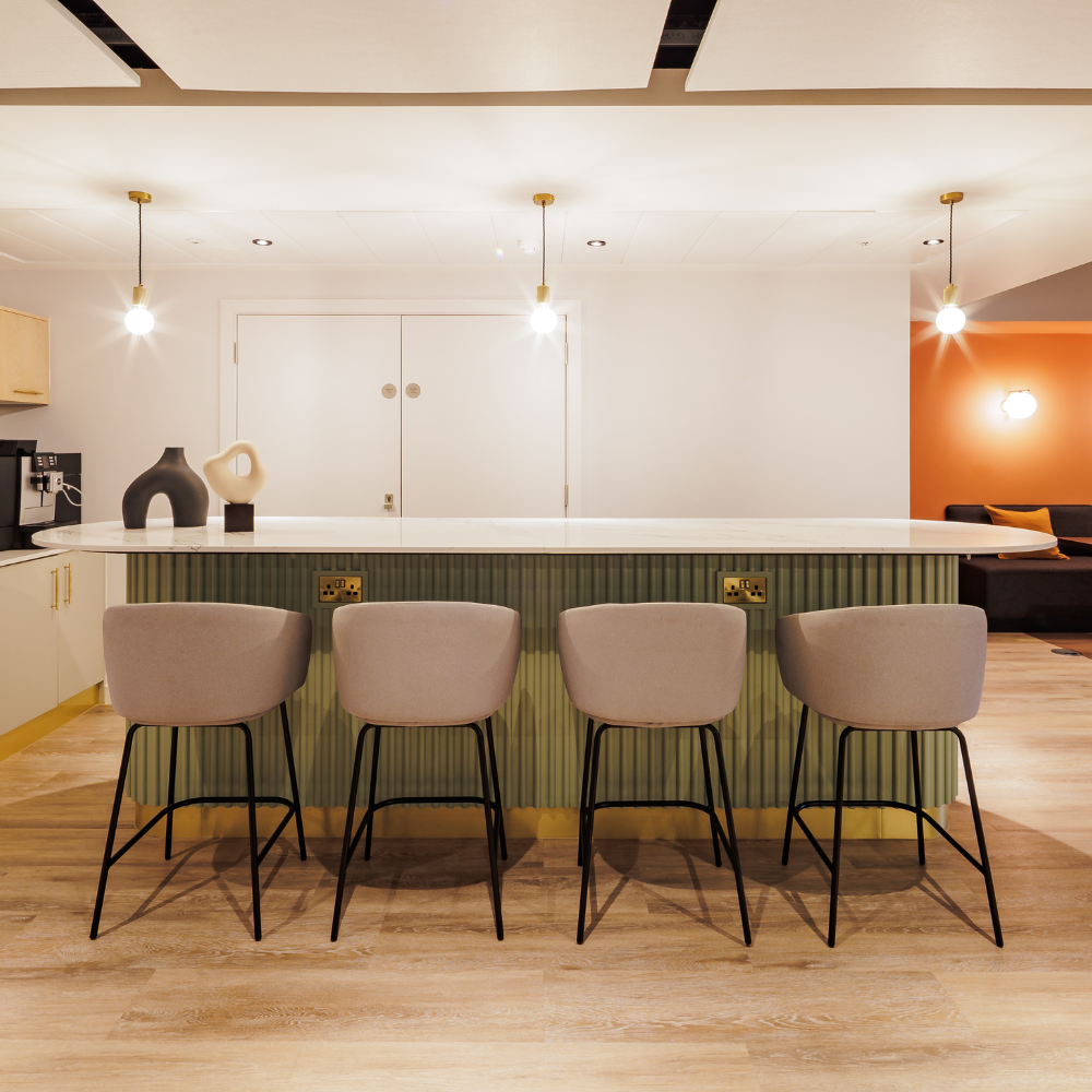 Club lounge at 10X Brindleyplace, event space in Birmingham, featuring an island with stools, coffee station and banquette seating, ideal for catering and receptions.